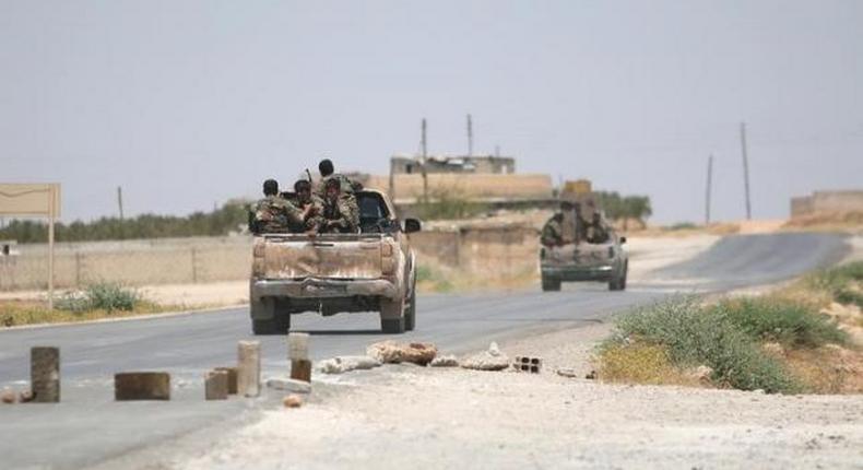 Syria Democratic Forces (SDF) ride vehicles along a road near Manbij, in Aleppo Governorate, Syria, June 25, 2016.