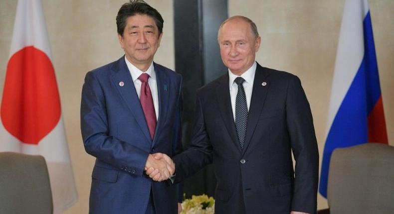 Russian President Vladimir Putin (R) met with Japan's Prime Minister Shinzo Abe in Singapore on November 14, although their nations are technically at war