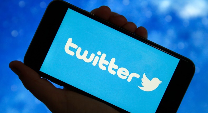 Twitter logo is displayed on the screen of a smartphone.