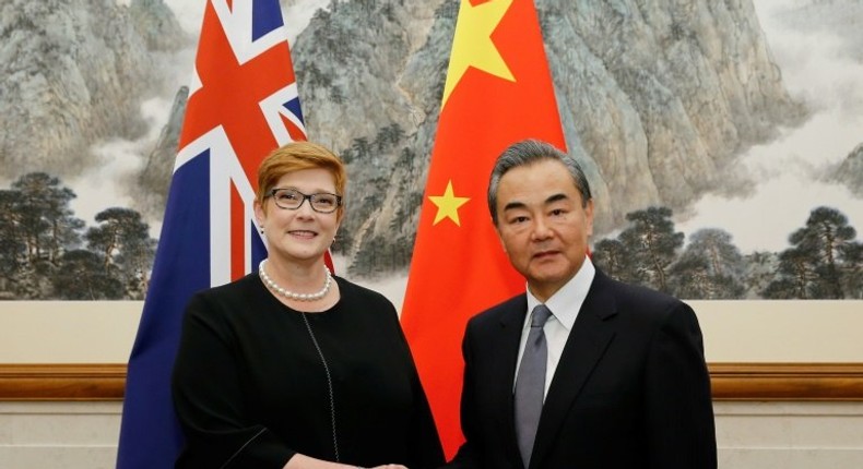 Australian Foreign Minister Marise Payne (L) says she raised the Xinjiang internment camps in talks with China's top diplomat Wang Yi (R)