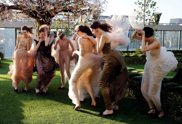 Models struggle against strong wind before the rehearsal of Christian Dior's Haute Couture Spring-Su