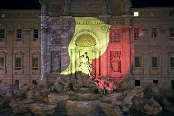 The black, yellow, and red colours of the Belgian flag are projected on the Trevi fountain in Rome, 