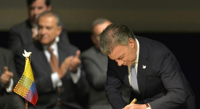 Colombian President Juan Manuel Santos signs the historic peace agreement between the Colombian government and the Revolutionary Armed Forces of Colombia in Bogota, on November 24, 2016