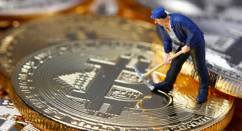 FILE PHOTO: A small toy figure is seen on representations of the Bitcoin virtual currency in this illustration picture, December 26, 2017. REUTERS/Dado Ruvic/Illustration