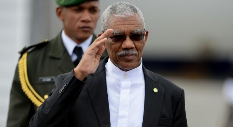 The ruling coalition of Guyana's President David Arthur, pictured in 2017, is in a tight race with theopposition People's Progressive Party