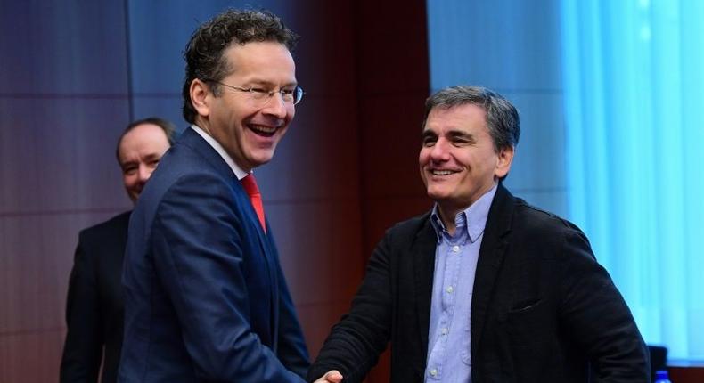 Eurogroup President and Dutch Finance Minister Jeroen Dijsselbloem (L) and Greece's Finance Minister Euclid Tsakalotos speak together ahead of a Eurogroup finance ministers meeting at the European Council in Brussels, on December 5, 2016