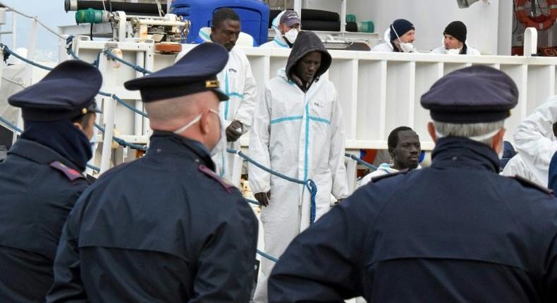 Migrants disembark in the port of Messina, Sicily, following a rescue operation at sea on February 1, 2016