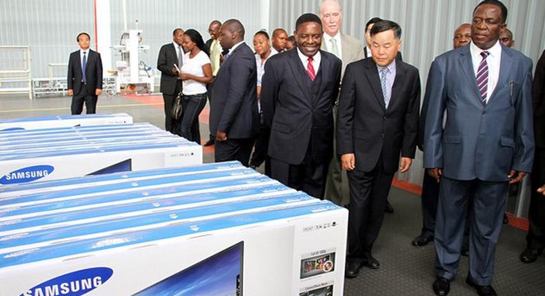 Acting President Emmerson Mnangagwa tours the SamZim plant, which assembles Samsung electronic gadgets, accompanied by the firm’s chairman Mr YC Baik and Director-General in the President’s Office Retired Major-General Happyton Bonyongwe in Harare