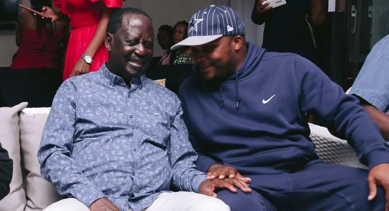 ODM leader Raila Odinga speaks with Lang'ata MP Jalang'o during a birthday party at Saboti MP Caleb Amisi's house