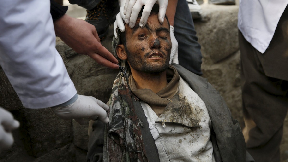 Doctors check on a man during a police round up of suspected drug addicts, in Kabul, Afghanistan