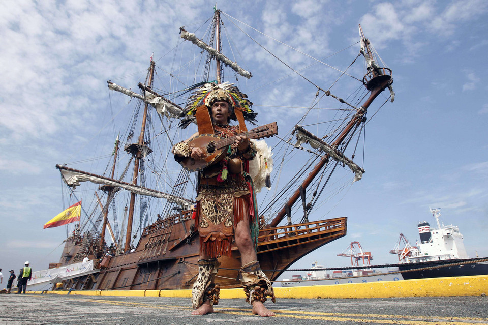 Vicente Reyes Kandoche performs to welcome a replica of a 17th century Spanish galleon which docked at Manila harbor