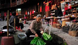 Elderly lady washing vegetables inside a tulou in Fujian, China.Sheng Li/Reuters
