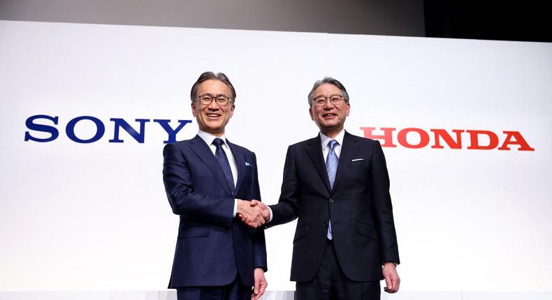 Sony president and CEO Kenichiro Yoshida (L) and Honda president Toshihiro Mibe shake hands after announcing the partnership in March.BEHROUZ MEHRI / Contributor / Getty