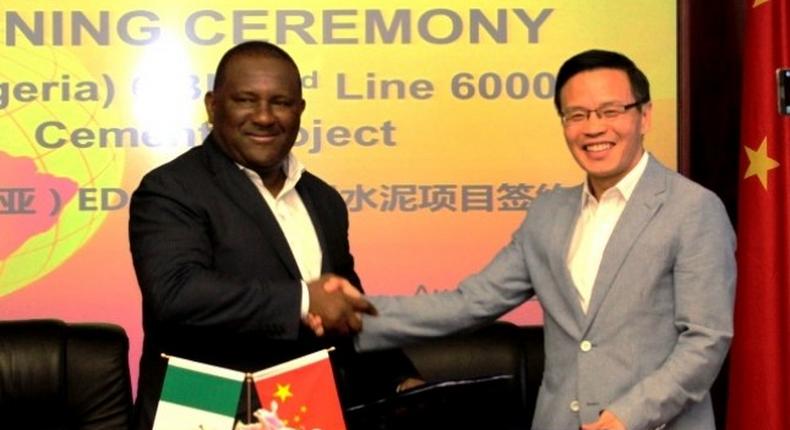 Abdulsamad Rabiu, Chairman, BUA Group and Tong Laigou, Board Chairman, SINOMA CBMI, shake hands and exchange documents after signing a USD600 million deal to expand BUA's cement capacity in Africa.