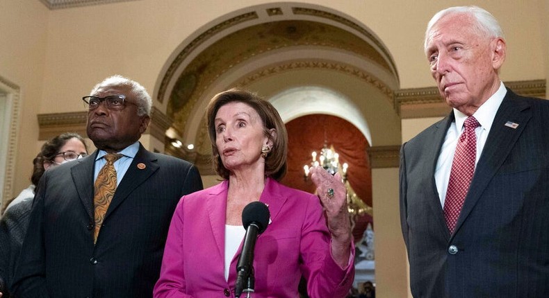 Speaker of the House Nancy Pelosi, D-Calif., accompanied by House Majority Whip James Clyburn, D-S.C., left and House Majority Leader Steny Hoyer D-MD, speaks to reporters at the Capitol in Washington, Friday, Nov. 5, 2021