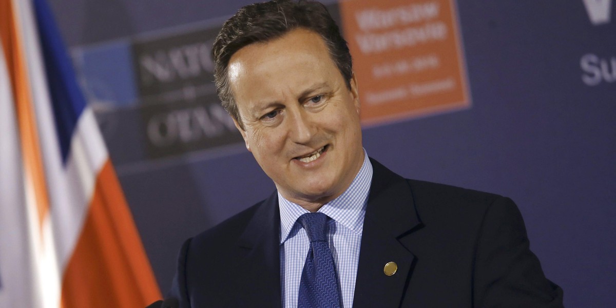 British PM Cameron speaks during a news conference at the PGE National Stadium, the venue of NATO summit, in Warsaw