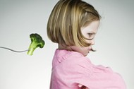 Young Girl Refusing To Eat Her Greens