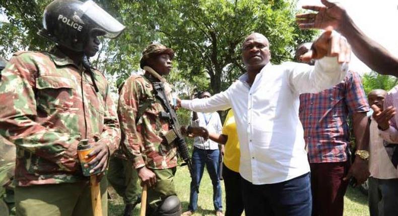 File image of Rashid Echesa surrounded by police at a past event