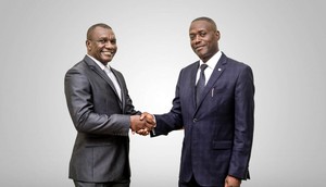 Daniel Ligyalingi, outgoing board chairman (L) and Joseph Lubaale Bagabo the new board chairman (R)