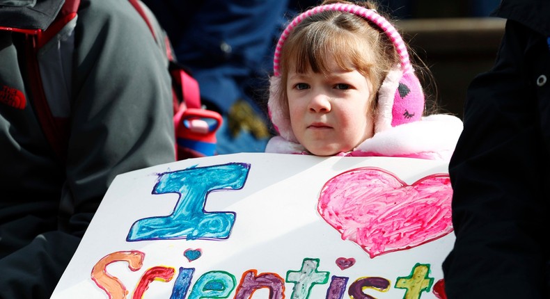 Analeigh Belisle of Fort Collins, Colo., holds a sign before a march for science Saturday, April 22, 2017, in Denver