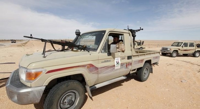 A Libyan soldier sits in a military vehicle at checkpoint in Wadi Bey, west of the Islamic State-held city of Sirte, February 23, 2016. 