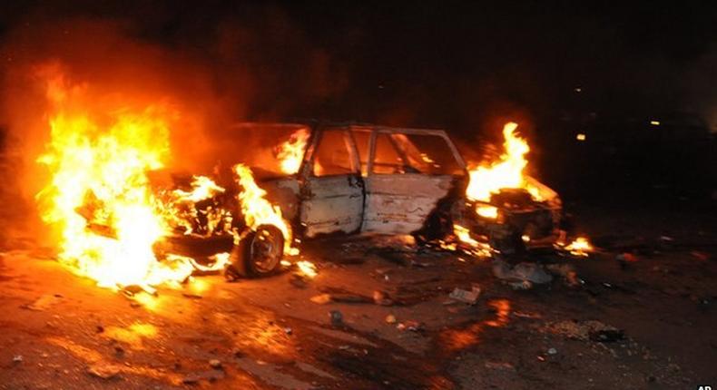 Car burns following a bomb blast in Abuja on 1 May 2014