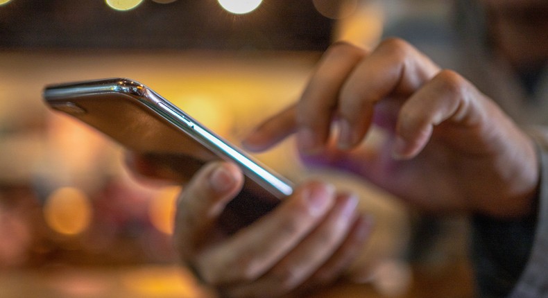 A stock image of a person scrolling on a cell phone.boonchai wedmakawand/Getty Images