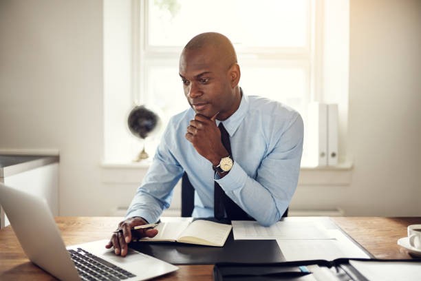 A man using a laptop in an office