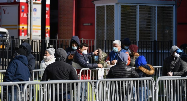 New Yorkers queue outside Elmhurst Hospital Center in Queens to get tested for the coronavirus