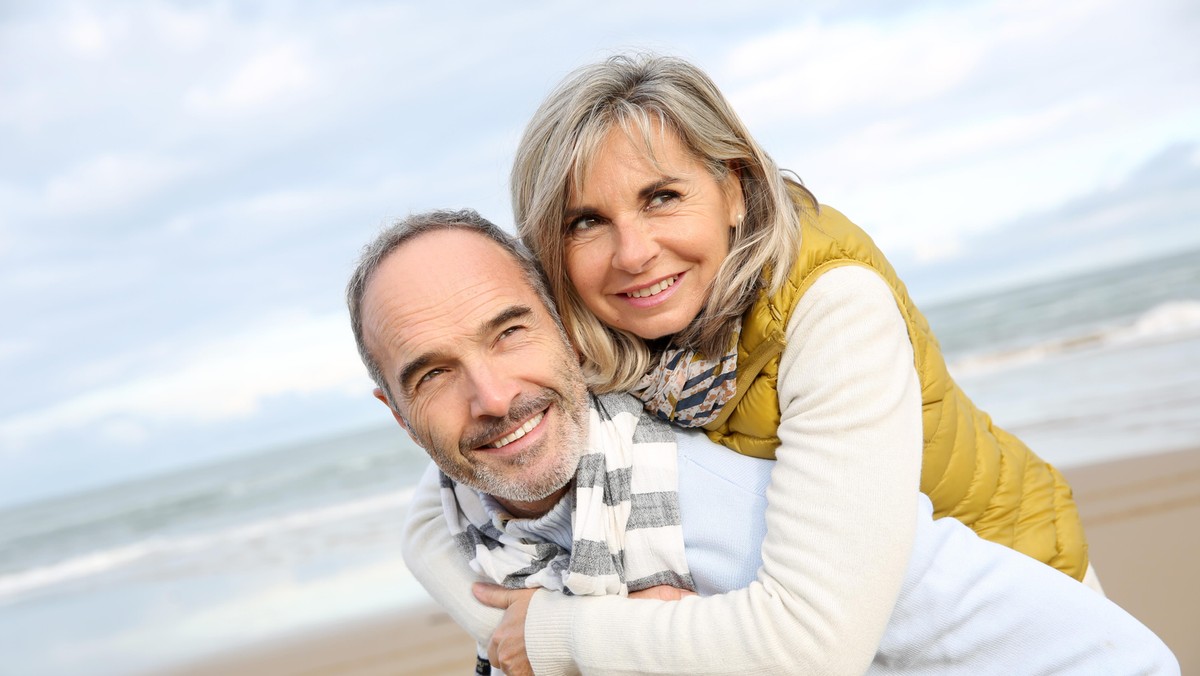 Senior man giving piggyback ride to wife