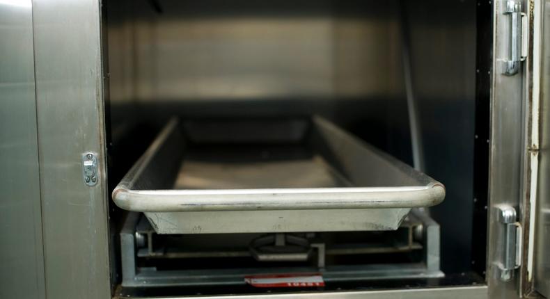 Open hospital morgue drawers used for the storage of human bodies awaiting identification or autopsy.
