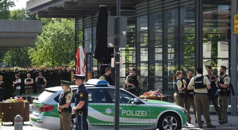 Police secure the area around a rail station near Munich where shots were fired. A female police officer was badly injured and several people were wounded