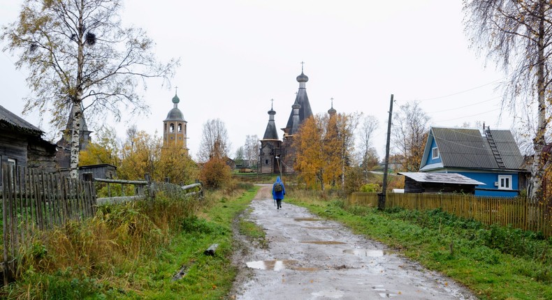 In this photo taken Oct. 7, 2018, a person walks down a street in the village of Nyonoksa, northwestern Russia.