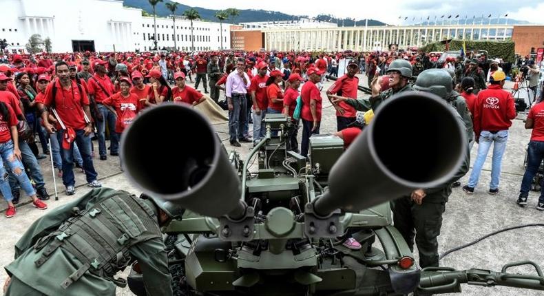 Members of Venezuela's army show civilians how to handle an anti-aircraft battery during military drills