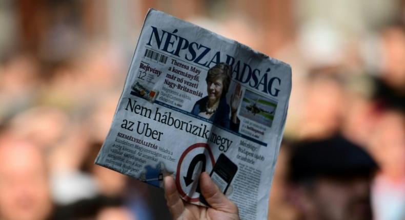 A person holds a copy of Nepszabadsag daily during a protest by journalists of Hungary's biggest opposition newspaper Nepszabadsag and their supporters in Budapest on October 16, 2016