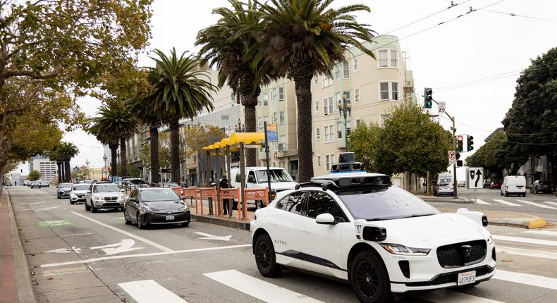 Waymo self-driving taxis are kitted out with cameras and other sensors, like this Jaguar model crossing an intersection in San Francisco.JASON HENRY/Getty Images