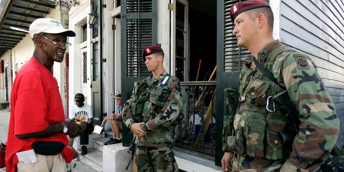 Members of the National Guard talk to Hurricane Katrina holdouts in New Orleans on September 11, 2005.