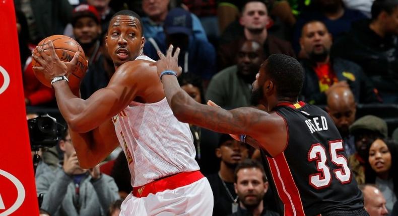 Dwight Howard of the Atlanta Hawks grabs a rebound against Willie Reed of the Miami Heat at Philips Arena on December 7, 2016