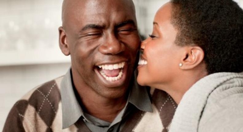 Young lady kissing older man