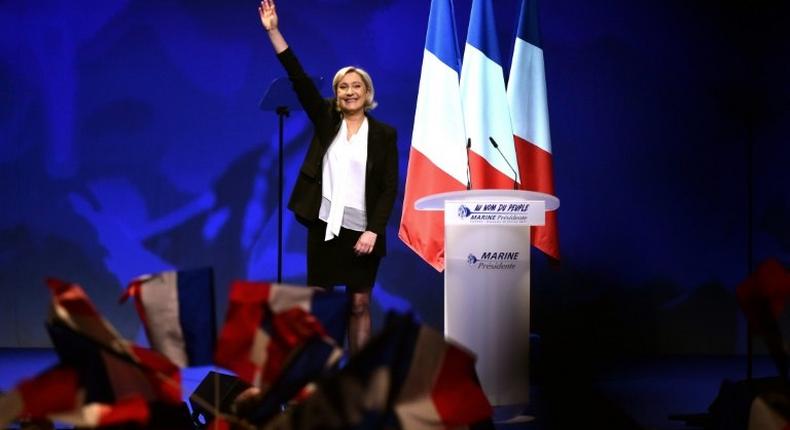 French far-right Front National (FN) party candidate for the presidential election Marine Le Pen acknowledges applause after speaking on stage during a campaign rally at the Zenith de Nantes venue in Saint-Herblain on February 26, 2017