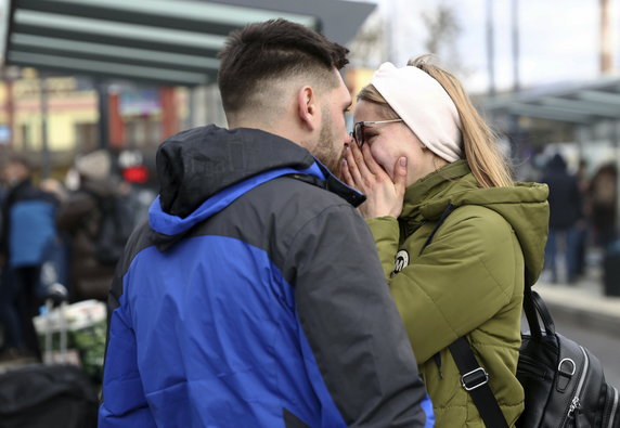 Para przytula się na dworcu we Lwowie, po decyzji o opuszczeniu Ukrainy i wyjeździe do Polski