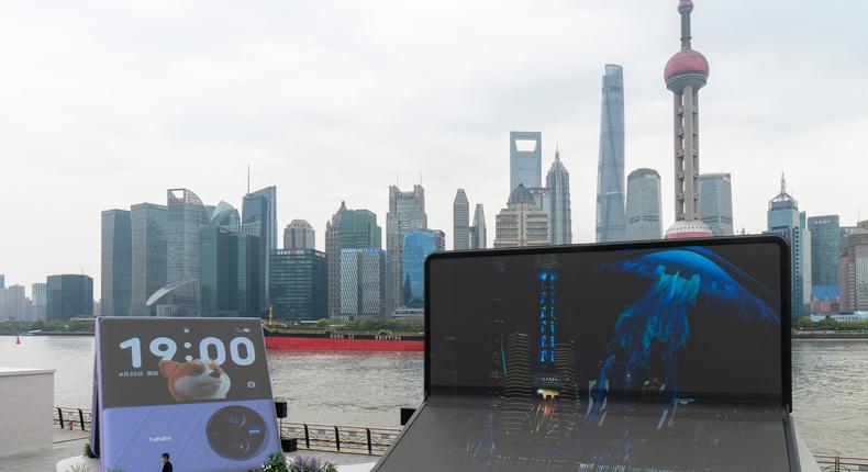 People walk by installations advertising Vivo X Fold 2 foldable smartphone and X Flip foldable smartphone at The Bund on April 11, 2023 in Shanghai, China.VCG Getty Images