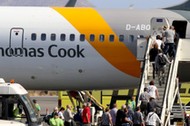 Passengers board a Thomas Cook airplane at the Heraklion airport on the island of Crete