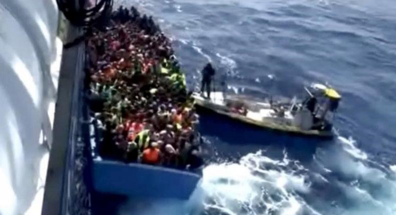 A boat full of migrants is seen next to Swedish ship Poseidon during a rescue operation in the sea off the coast of Libya in this still image taken from an August 26, 2015 video. REUTERS/Swedish Coast Guard Handout via Reuters TV -