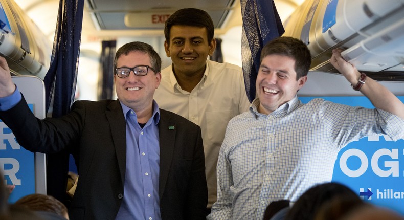 From left, outside advisor Philippe Reines, press aid Varun Anand, and Traveling Press Secretary Nick Merrill, right, smile while speaking with members of the media aboard Hillary Clinton's press plane on Nov. 2, 2016.