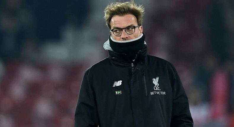 Liverpool's coach Jurgen Klopp watches as his players warm up ahead of the EFL Cup semi-final second-leg football match against Southampton on January 25, 2017