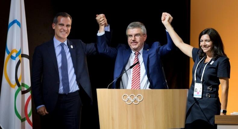 L-R: Mayor of Paris Anne Hidalgo, International Olympic Committee President Thomas Bach and Los Angeles Mayor Eric Garcetti pose on July 11, 2017 in Lausanne