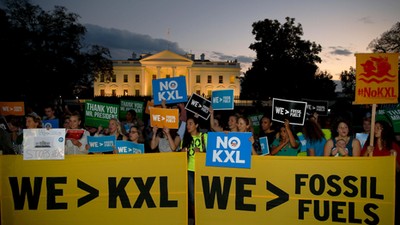 A small group of activists gather to celebrate the Obama administration's rejection of the Keystone 