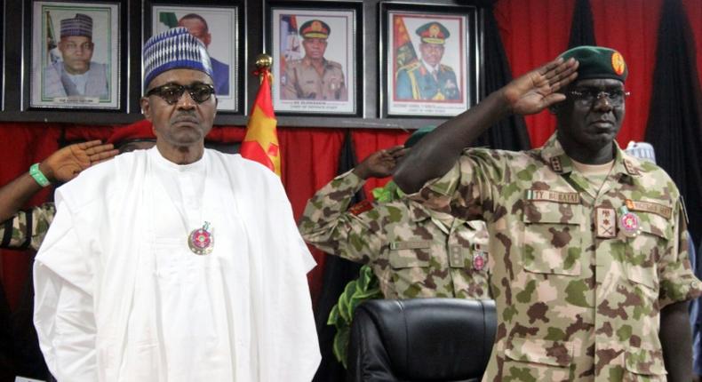 Buhari, left, pictured next to Chief of Army staff Tukur Yusuf Buratai at ceremonies for an annual military conference last November