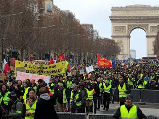 Protesters wearing yellow vests take part in a demonstration by the "yellow vests" movement in Paris